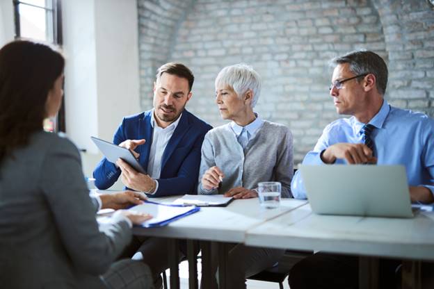 Older coworkers looking at papers - Age Discrimination